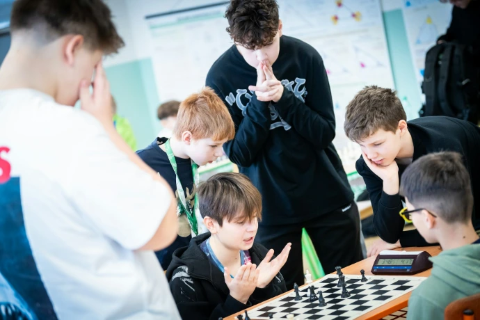 A group of young men playing a game of chess